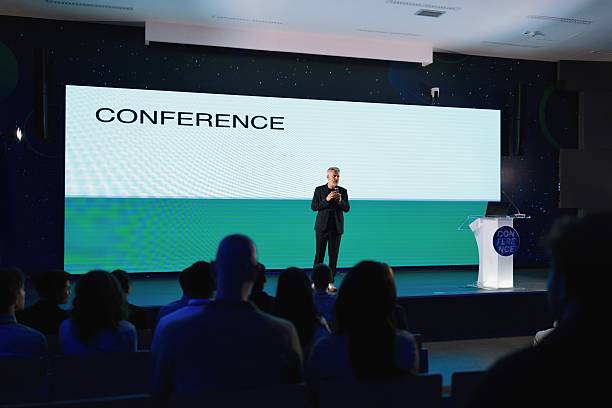 istock Presenter Delivering Keynote Speech on Technology at Modern Conference Hall 2224110762