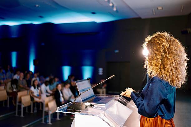 istock Confident Woman Presenting on AI Design at Modern Technology Conference 2224110887