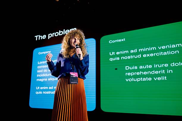 istock Confident Woman Presenting on AI Design at Modern Technology Conference Stage 2224110921