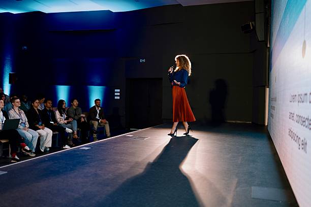 Confident Speaker Presenting at Modern Technology Conference in Professional Venue