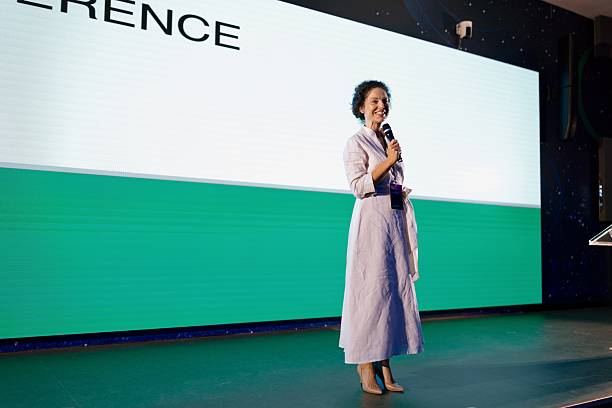 istock Confident Speaker Addressing Audience at Modern Technology Conference in Professional Setting 2224110984