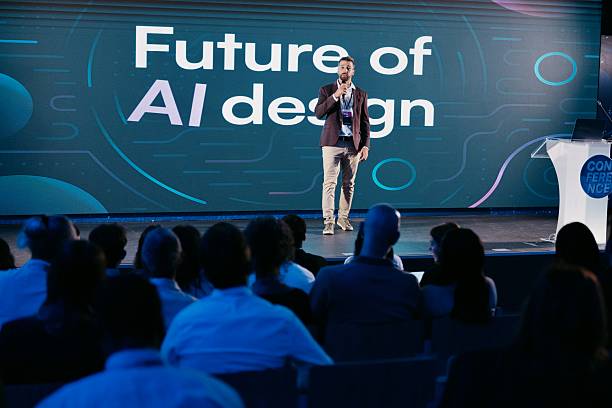 istock Speaker Discussing AI Innovations at Technology Conference with Engaged Audience 2224111062