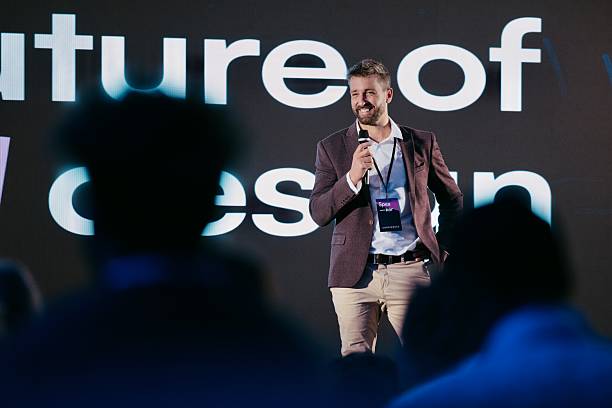 istock Confident Speaker Presenting AI Design Innovations at Technology Conference with Modern Background 2224111091