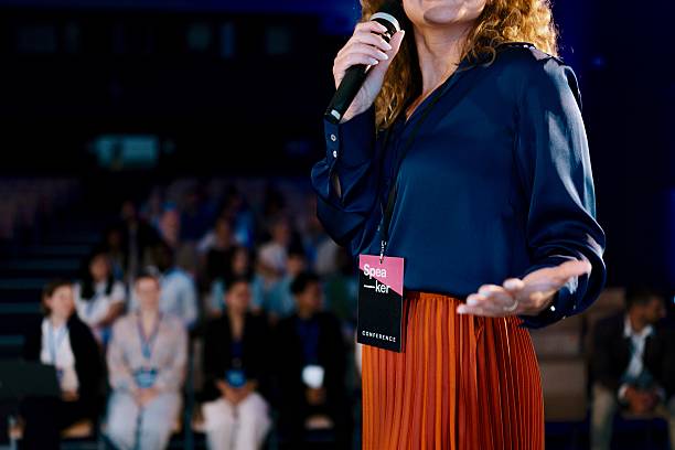 istock Confident Woman Presenting on Stage at a Modern Tech Conference 2224111110