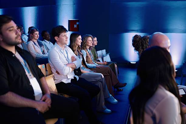istock Diverse Audience Watching a Speaker at a Modern Business Conference 2224111155