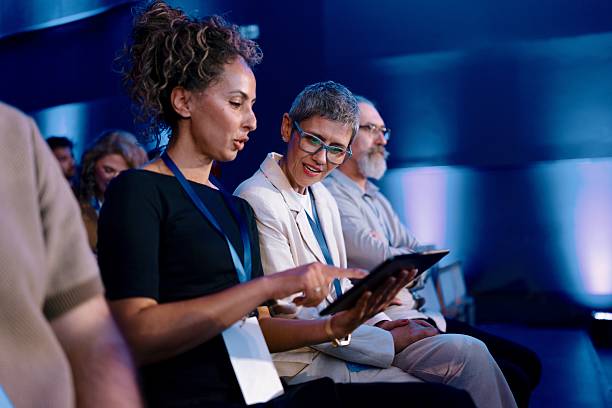 istock Diverse Professionals Interacting During a Business Conference in a Modern Event Space 2224111179