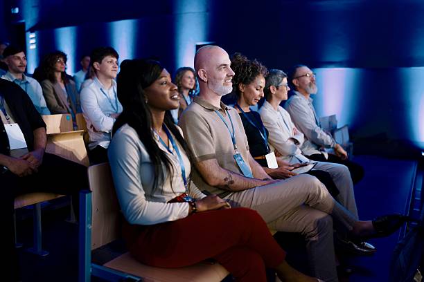 istock Diverse audience listening to presentation at conference 2224111182