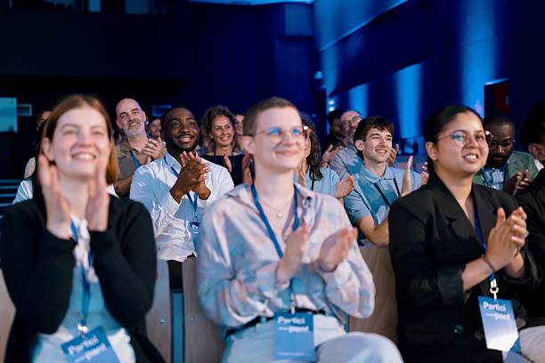 istock Diverse Professionals Attentively Applauding Speaker at Modern Business Conference 2224111255