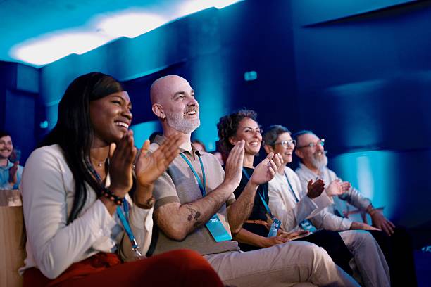 istock Diverse Professionals Applauding Enthusiastically at a Modern Business Conference 2224111286