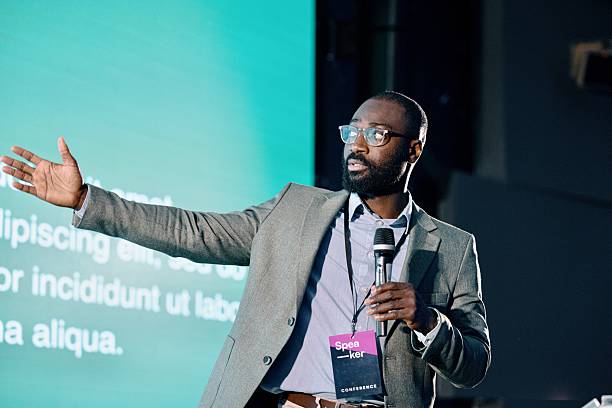istock Confident Speaker Presenting Ideas During Business Conference Presentation in Modern Venue 2224111314