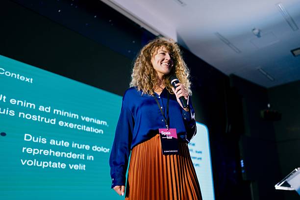 istock Confident Speaker on Stage at a Professional Technology Conference Presentation Event 2224111338
