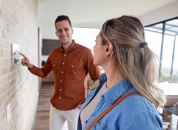 istock Couple leaving their house and locking the door using an automation system 2224111855