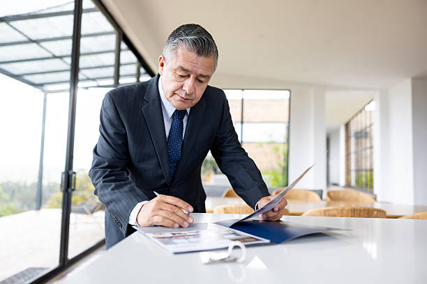 istock Real estate agent organizing brochures while getting ready for an open house 2224111949