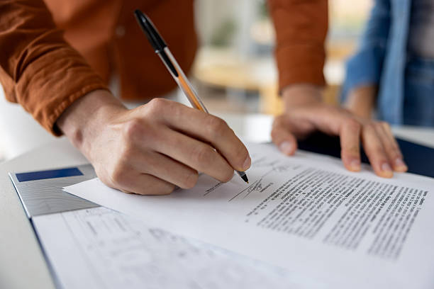 istock Man signing a deed while buying a house 2224111954