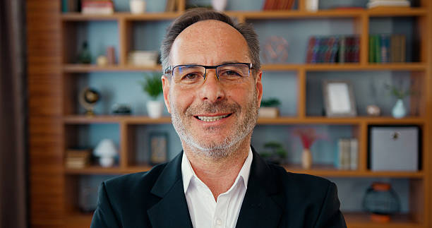 istock Smiling happy confident handsome smart middle aged entrepreneur, businessman posing in office. Close up face of bearded professional businessman in eyeglasses turning and looking at the camera 2224112073