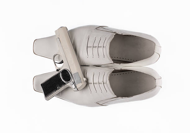 white mafia shoes and gun isolated on white background