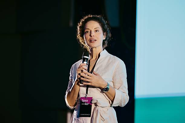istock Confident Woman Speaking at Technology Conference in a Professional Setting 2224113025