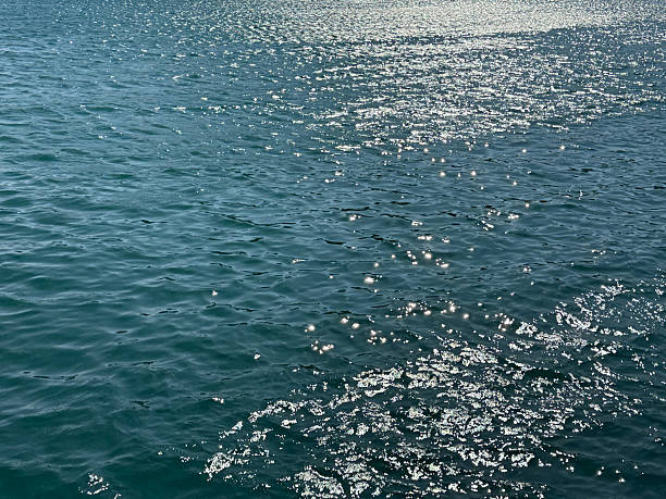 istock Blue glittering ocean water with sun reflections on surface. 2224113269