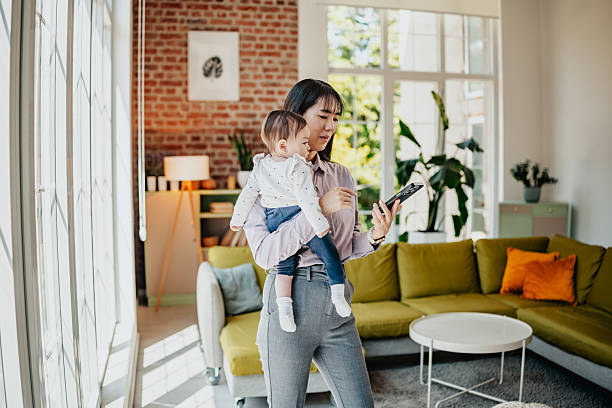 istock Mom using voice search while holding baby 2224114758