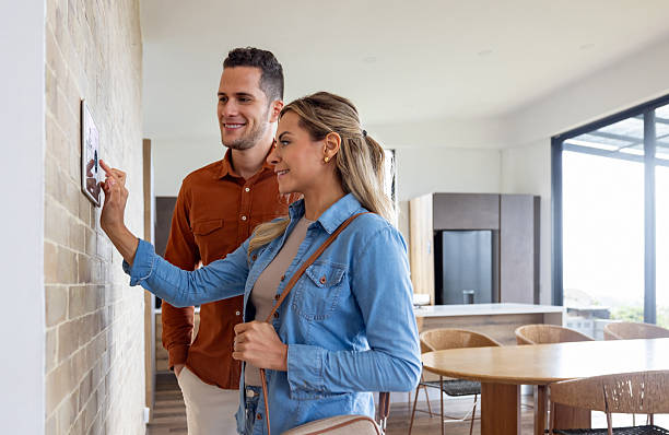 istock Couple locking the door using an automation system as they leave their home 2224116083