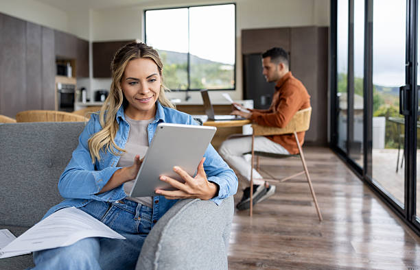 istock Couple working at home and woman using a digital tablet 2224116095