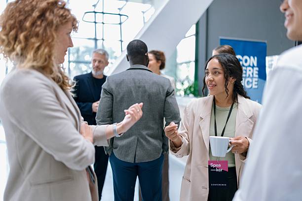 istock Group of professionals networking and chatting informally at a corporate event. 2224118764