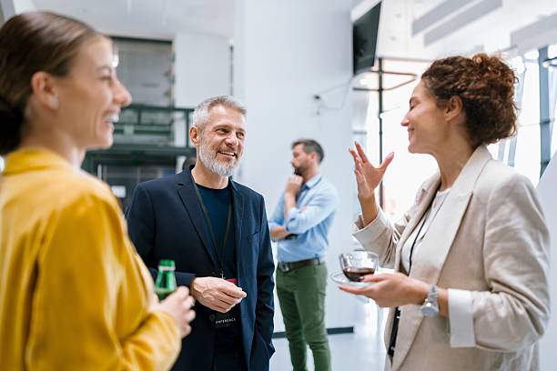 istock Colleagues chatting and smiling in hallway during conference intermission 2224118805