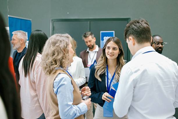 istock Young female entrepreneur discussing with delegates during networking event at convention centar 2224118836