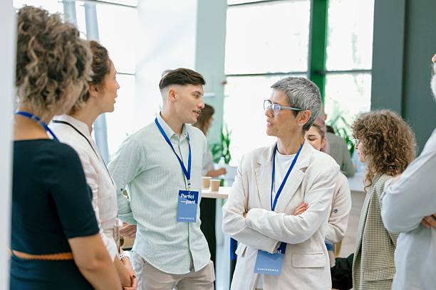 istock Business people enjoying conversation with diverse colleagues during break from conference 2224118840