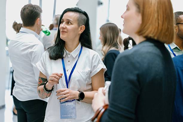 istock Group of professionals having friendly discussion during coffee break at business event 2224118871