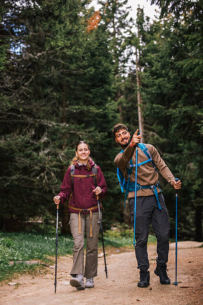 istock Curious Hiking Couple Observing the Distant View in Mountain Forest 2224118953