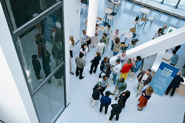 istock Overhead shot of professionals talking at networking session 2224118963