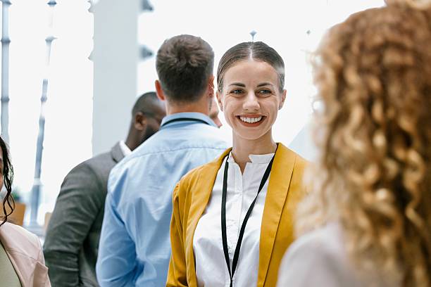 istock Colleagues chatting and smiling in hallway during conference intermission 2224119351