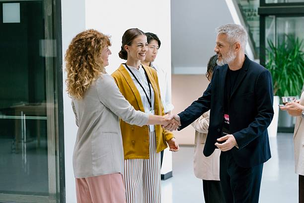 Woman introducing her friend to others at networking event