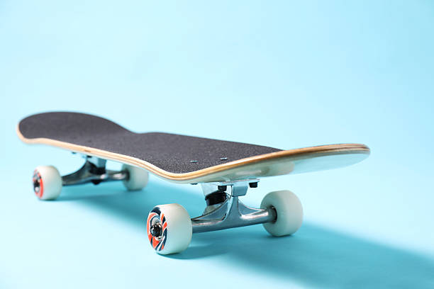 istock One skateboard on light blue background, closeup. Sports equipment 2224120948