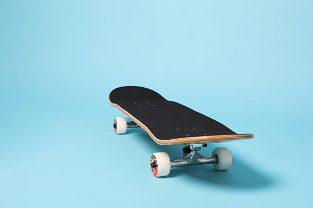 istock One skateboard on light blue background, space for text. Sports equipment 2224120991