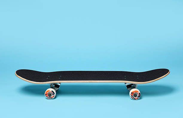 istock One skateboard on light blue background. Sports equipment 2224120995