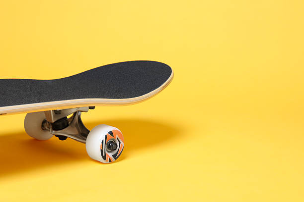 istock One skateboard on yellow background, closeup. Space for text 2224121045