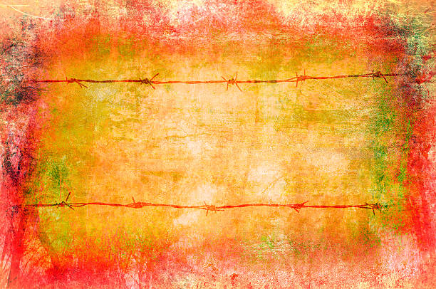 Art grunge background in red, yellow and orange showing barb wired fence.