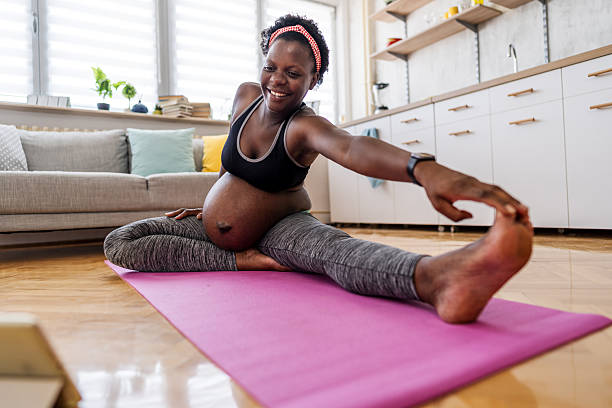 istock Pregnant woman practicing yoga at home 2224122513