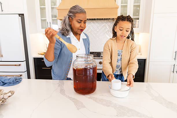 Multigenerational family bonding while making iced tea.  Happiness, teamwork, and togetherness.