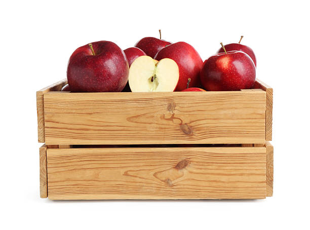 Fresh ripe red apples in wooden crate isolated on white