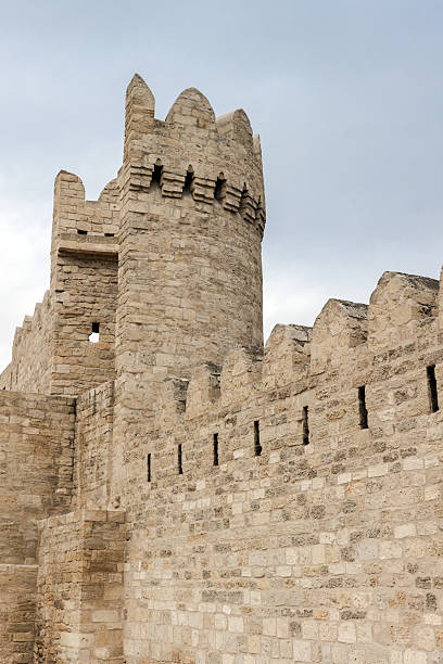 istock Ancient stone fortress walls featuring a textured round tower under a blue sky 2224122933