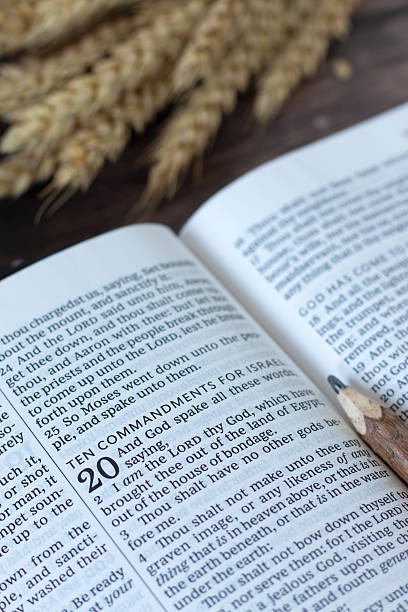 istock Ten commandments text in open holy bible book with wheat in the background 2224130115