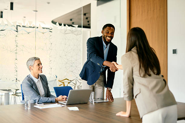 istock Business Professionals Shaking Hands in Modern Office 2224132610