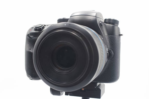 istock Professional DSLR camera with large lens positioned on a tripod against a white background 2224132932