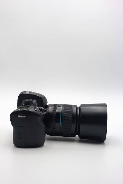 istock Digital camera with a large lens positioned horizontally on a plain background showcasing its design and features 2224132947