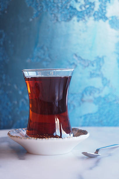 Traditional turkish tea served in glass with decorative saucer on table
