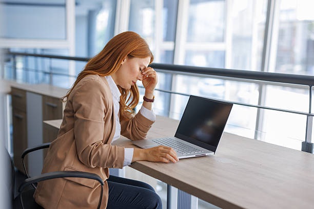 istock Stressed businesswoman working on laptop in office 2224133936