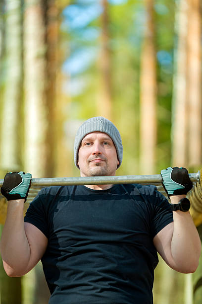 A strong man demonstrates his lifting capabilities while performing an intense training session, capturing the essence of dedication to fitness in a dynamic environment.